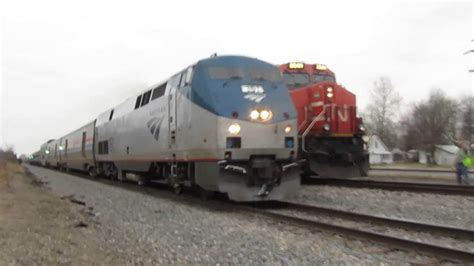 21117 Amtrak 392 Passes Canadian National Freight Train Youtube