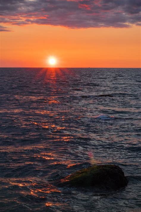 Dark Orange Sunset Ocean Portrait With Warm Color Tones Stock Image