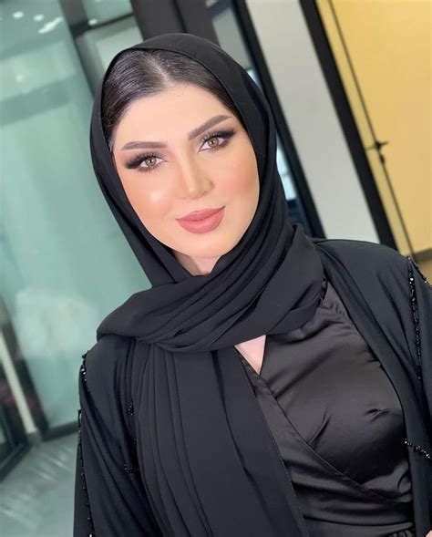 A Woman Wearing A Black Hijab And Posing For The Camera