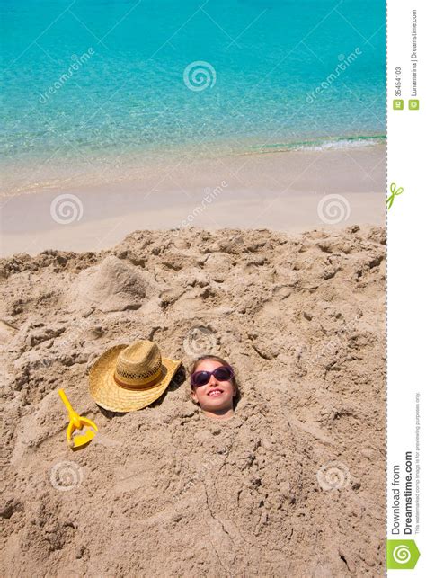Funny Girl Playing Buried In Beach Sand Smiling Sunglasses Stock Image