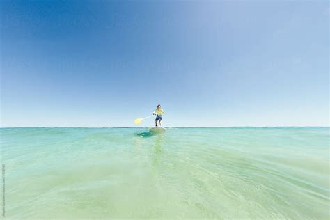 Riding A Wave On A Sup At The Beach In Summer By Angela Lumsden