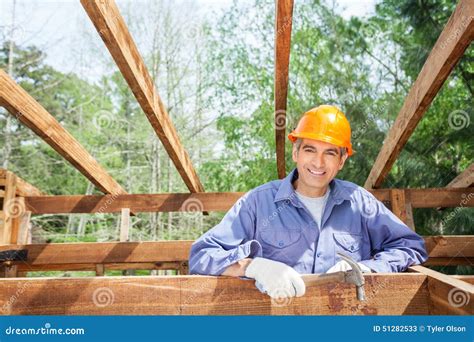 happy construction worker holding hammer at site stock image image of caucasian house 51282533