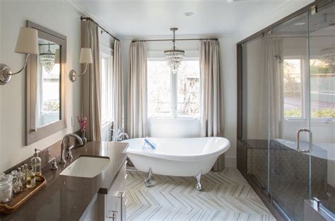 Luxurious Master Bathroom With Warm Tone Of Tile And Stone Bath