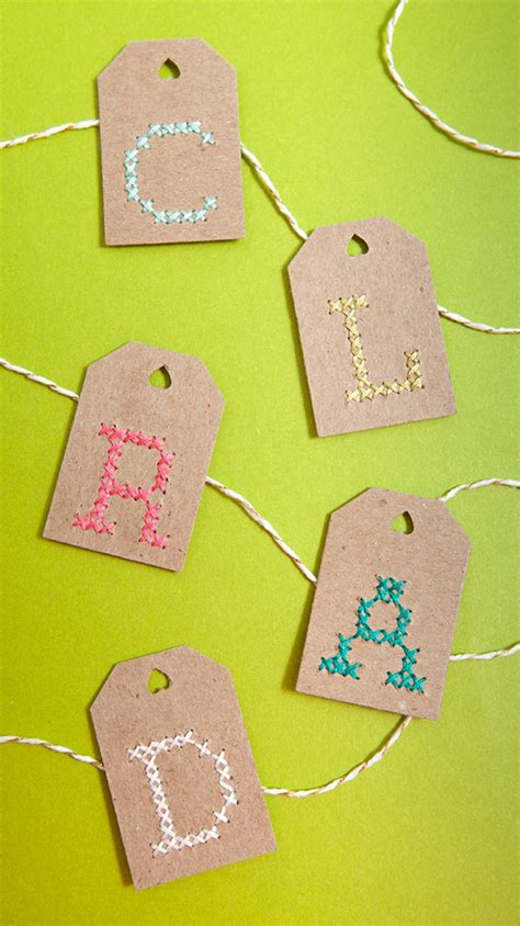 In preparation for the piercing needed, stack 4 small pieces of felt together to serve as the base.the felt behind the tag makes it easy to pierce the holes without nicking your table in the process. Learn How To Cross-stitch Alphabet Gift Tags!