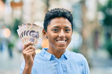 Young African American Girl Smiling Happy Holding Mexican 500 Pesos