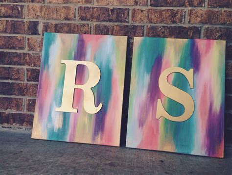 Gold Spray Painted Wooden Letters On Abstract Canvases