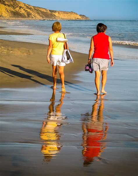 Friends Sharing A Walk On The Beach Shutterbug