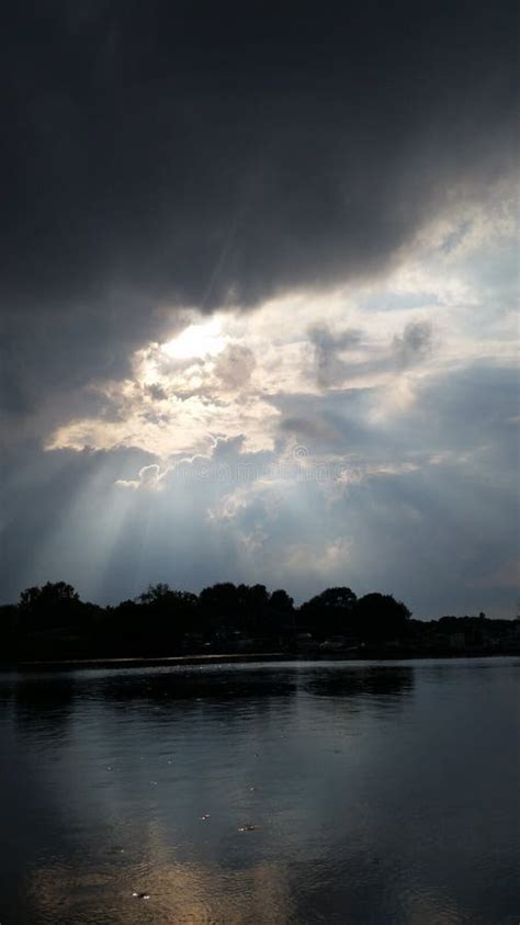Sunbeams Through The Clouds Over The Water Stock Photo Image Of