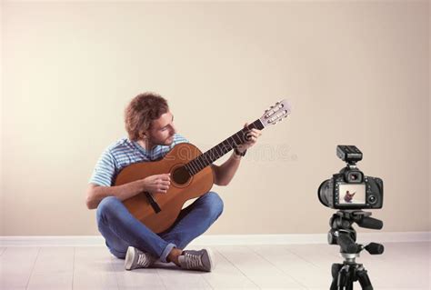 Music Teacher Recording Guitar Lesson Near Wall Stock Image Image Of