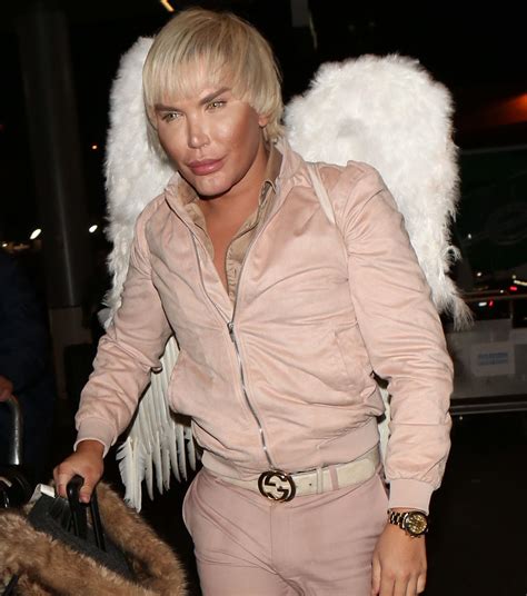 Human Ken Doll Rodrigo Alves Ready For Take Off Wearing Fluffy Angel Wings At LA Airport Before
