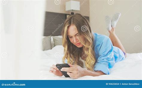 Woman In A Shirt Lies On A Bed Kicking Feet And Dreaming Stock Footage Video Of Attractive