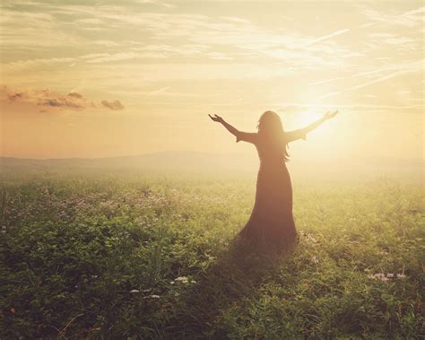 A Woman Lifts Her Arms In Praise At Dawn Royalty Free Stock Image