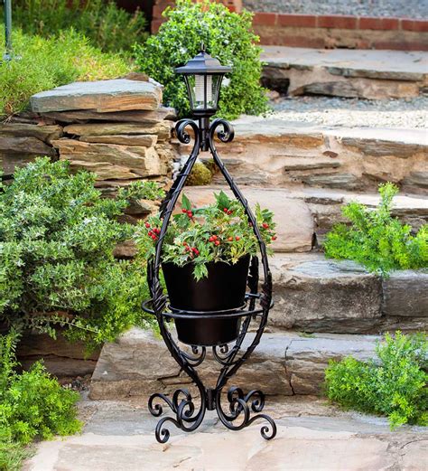 Black Wrought Iron Plant Stand With Solar Light Plants And Planters