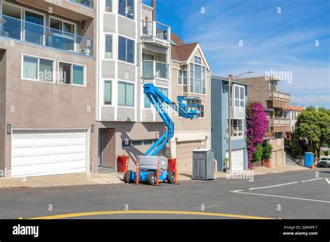 Row of complex houses in San Francisco, California with boom lifter at