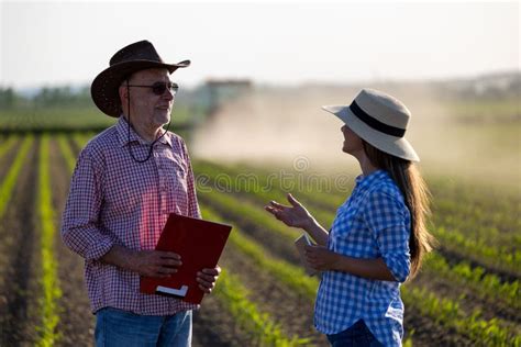 Man And Woman Farmers Talking In Agricultural Field In Spring Stock Image Image Of Female