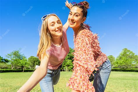 Premium Photo Two Women Best Friends Having Fun In A City Park Posing For A Happy Selfie