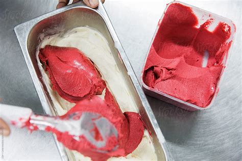 Person Mixing Strawberry And Vanilla Ice Cream Together By Stocksy