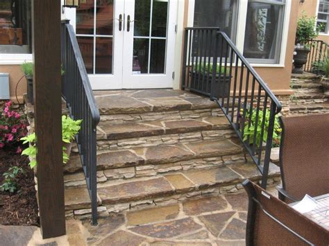 Flagstone Steps And Black Iron Rail Leading Down From Screen Porch In