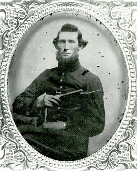 an old black and white photo of a man in uniform