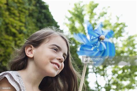 Smiling Girl Holding Pinwheel Outdoors High Res Stock Photo Getty Images