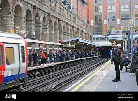 People Passengers Waiting On The Platform At Barbican Station Tube