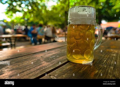 Glass Of Fresh Beer In A Traditional Bavarian Beer Garden In Munich