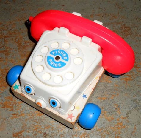 An Old Fashioned Phone With Blue Wheels On The Floor Next To A Red