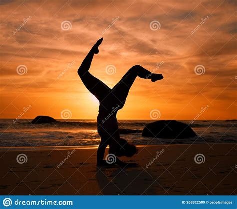 Yoga Silhouette Or Handstand Pose On Sunset Beach Ocean Or Sea In