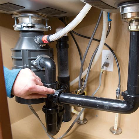 Clearing your kitchen double sink with a garbage disposal. Garbage Disposal Repair and Replacement