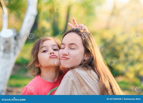 Two Cute Little Girls Hugging And Laughing At The Countryside Happy