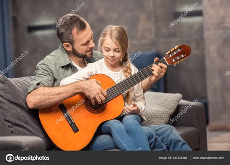Father And Daughter Playing Guitar — Stock Photo © Igortishenko 137333948