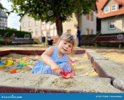 Adorable Little Girl On Playground In Sandpit Toddler Playing With