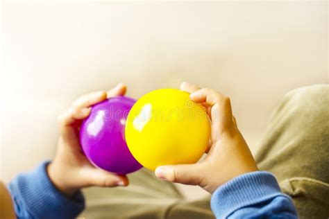 Hands Holding Purple And Yellow Two Balls Stock Image Image Of