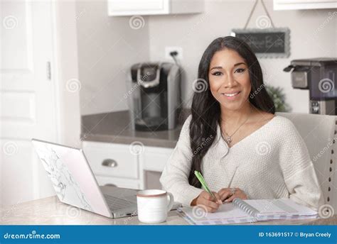 A Pretty African American Woman Works From Her Home Office In Her