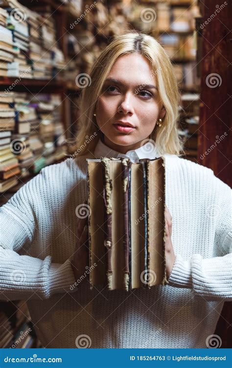 Pretty Woman Holding Books And Looking Away In Library Stock Image Image Of Retro Aged 185264763