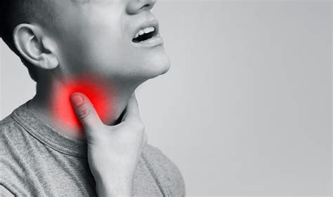 Young Man Suffering From Pain In Throat Touching Inflamed Neck Stock