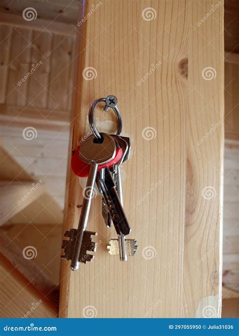 A Bunch Of Metal Keys Hangs On A Nail On A Wooden Wall Stock Photo