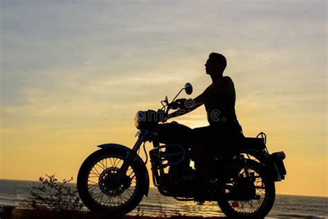 Silhouette Of Guy On Motorcycle On Sunset Background Young Biker Are