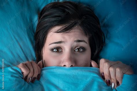 Girl Hides Her Face Under The Covers In Bed A Nightmare After Watching