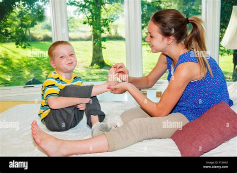 Two Children Tickling Feet Stock Photo Alamy