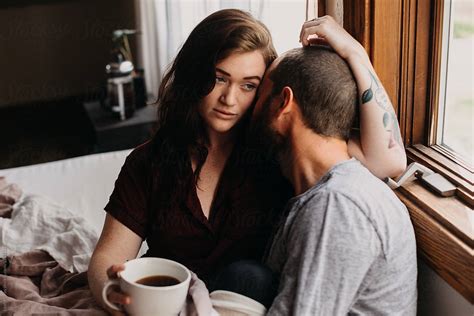 couple sharing coffee in bed by stocksy contributor leah flores stocksy