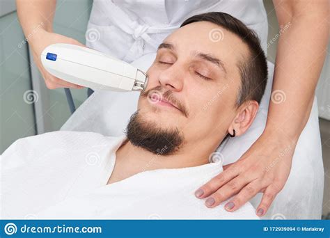 Man Having Laser Treatment At Beauty Clinic Stock Photo Image Of Face