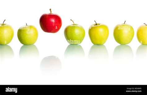 Red Apple Standing Out From Row Of Green Apples Stock Photo Alamy