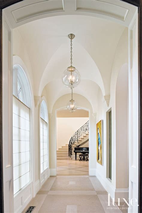 Hanging a swag light or light fixture from your ceiling may seem like a daunting task, but it's actually rather simple. Traditional White Foyer with Groin-Vaulted Ceiling ...