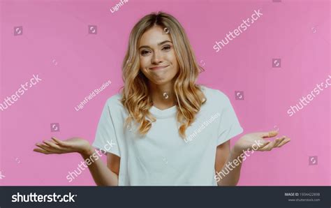 Confused Blonde Woman Showing Shrug Gesture Stock Photo Shutterstock
