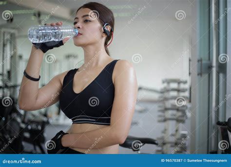 Sporty Woman Asia Drinking Water After Exercises In The Gym Fit Stock
