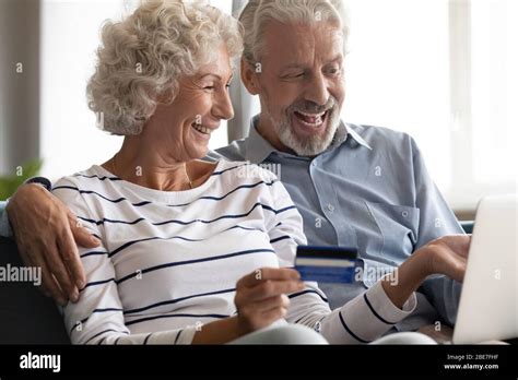 Excited Mature Couple Making Payment By Credit Card Online Stock Photo Alamy