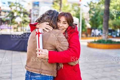 Two Women Mother And Daughter Hugging Each Other Surprise With T At