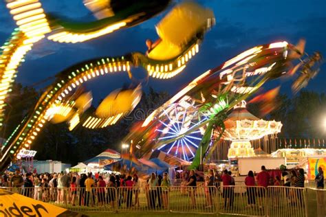 bright lights of carnival rides motion blur editorial image image 27624310