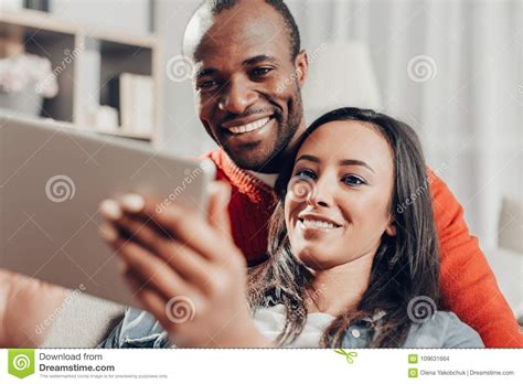 Smiling Pair Bonding To Each Other And Using Tablet Stock Photo Image